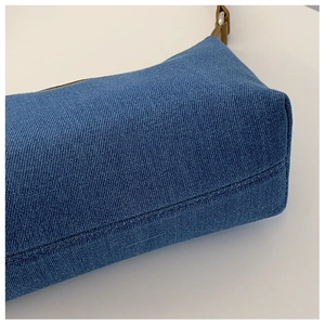 Detailed side view of vintage blue denim handbag showing premium stitching and fabric