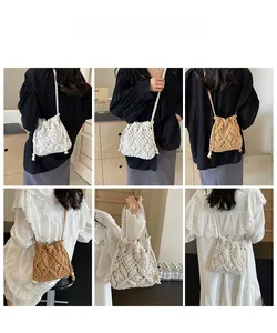 Detail of hand-woven straw bucket bag showing hollow diamond texture and tassel accents