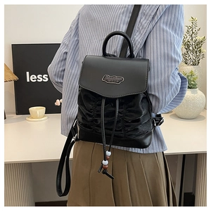Detail of black pleated mini backpack with Fashion BAG metal plaque and drawstring