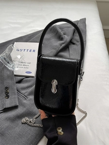 Black glossy patent leather handbag with silver turn-lock and elegant chain strap