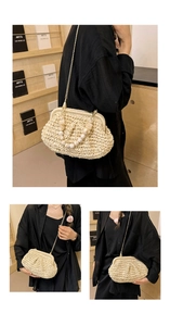 Detail view of woven straw cloud bag with golden chain and amber beaded handle
