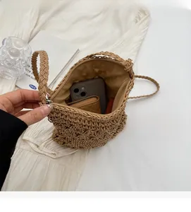 Interior view of woven straw bucket bag showing large capacity for phone and wallet