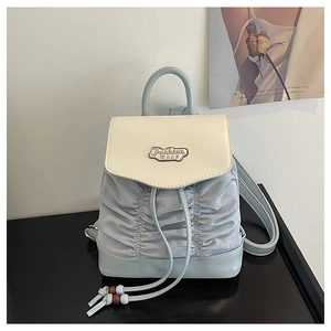 Detail of pleated mini backpack showing drawstring closure and Fashion BAG logo plaque