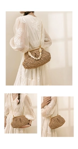 Detail of hand-woven straw cloud bag featuring ivory bead handle and gold chain strap