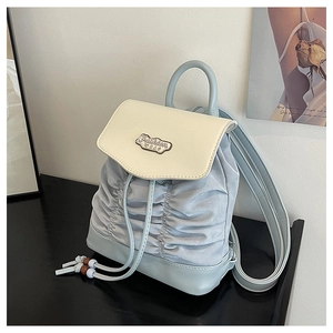 Detail of pleated texture and drawstring closure on a stylish mini backpack