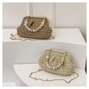 Detail of hand-woven straw bags with beaded handles and gold chain straps