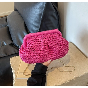 Detailed macro view of the fuchsia woven shell bag with textured straw pleats and gold chain