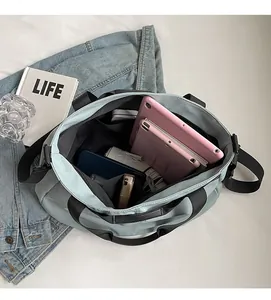 Top-down view of spacious bag interior holding a tablet, phone, and daily essentials