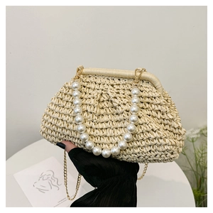Detailed close-up of a woven straw cloud bag with elegant pearl beads and gold chain