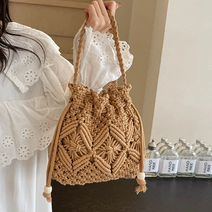 Handmade woven straw bucket bag with diamond hollow pattern and drawstring beads