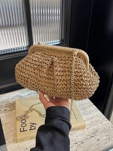 Handcrafted straw woven cloud bag with gold chain strap in earthy khaki for beach holidays