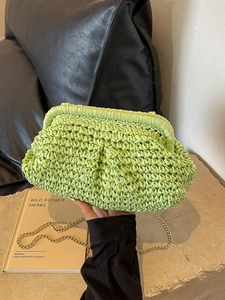 Light green woven straw seashell bag with gold chain strap for summer beach vacation