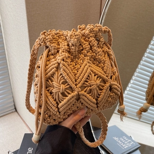 Handmade beige macrame bucket bag with drawstring closure and wooden bead accents