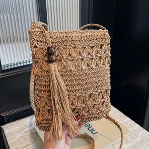 Women Handmade Straw Woven Crossbody Bag With Hollow Floral Pattern And Tassel Wooden Bead Decor For Summer Beach Vacation