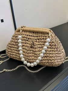 Summer woven straw handbag with large pearl handle and golden chain strap for beach vacation