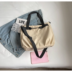 Top view of large capacity canvas tote bag with pink tablet and magazine for daily commute