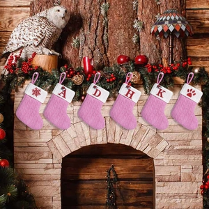 Pink knitted Christmas stockings set with letter embroidery and white faux fur trim
