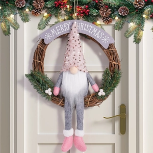 Detail of pink sequin hat gnome on a natural rattan Christmas wreath with pine needles