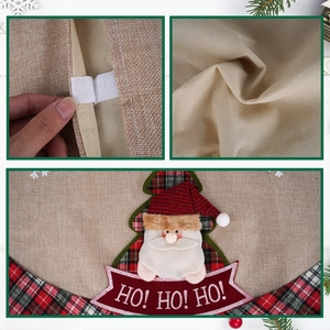 Detail showing the burlap texture, velcro closure and festive Santa embroidery on tree skirt