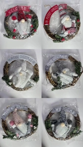 Macro view of Christmas gnome wreaths with branch frames and holiday banners