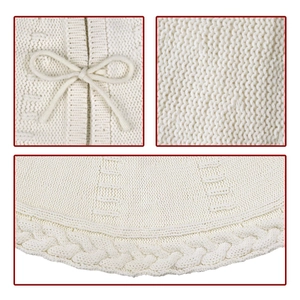 Detailed knit texture of ivory Christmas tree skirt with cable weave and bow tie detail