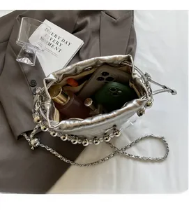 Detailed top view of a silver bucket bag with beads showing spacious inner compartment