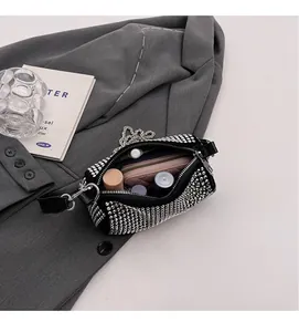Internal view of black rhinestone crossbody bag showing space for wallet and cosmetics