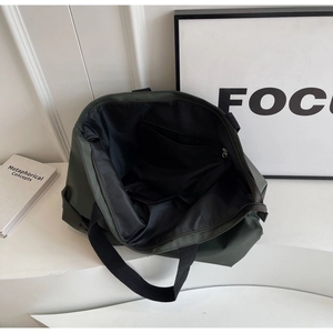 Top view of large olive green nylon tote bag showing black lining and interior zipper pocket