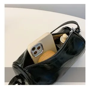 Interior view of the silver pillow bag showing capacity for phone and cosmetics