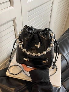 Fashionable black crocodile embossed bucket bag with silver butterfly charms and beaded handle