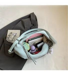 Macro shot showing large capacity interior of blue lychee leather bag with daily essentials