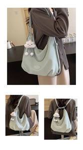 Detail of mint green lychee leather backpack with cloud pendant and chain accent