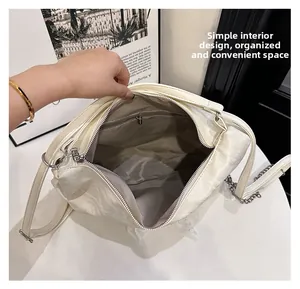 Interior view showing the large capacity main compartment and zipper pocket of the cream bag