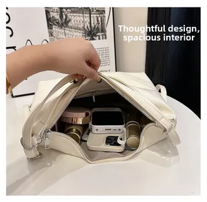 Detail view of the large capacity interior with zipper pocket and pebble leather texture