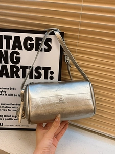 Chic silver cylinder pillow bag with metallic finish and adjustable shoulder strap