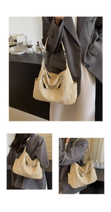 Detail view of woven straw tote bag featuring side pockets and silver metal hardware