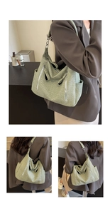 Close-up of light green woven texture with multiple functional zipper pockets and hardware