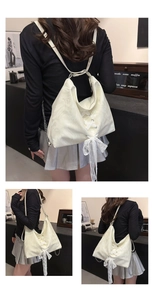 Detailed view of the white marble pattern PU tote bag featuring lace bow and silver chain