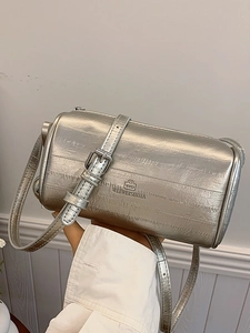 Sleek metallic silver cylinder pillow bag with adjustable shoulder strap and textured finish