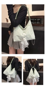 Detail of mint green marble pattern bag with lace bow and metal chain strap