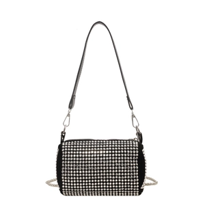 Black cylinder pillow bag with silver rivet studs and metal chain strap on white background