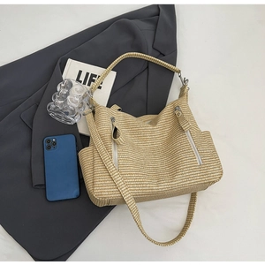 Detail of woven tote bag with beige checkered pattern and double vertical zipper pockets