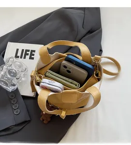 Spacious interior of yellow bucket bag showing phone and wallet storage capacity