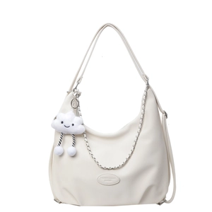 White large-capacity leather hobo bag with cloud charm and chain detail on white background