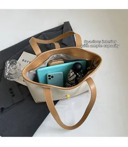 Detailed interior of a spacious cream tote bag showing capacity for tablets and daily items
