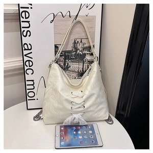 Detailed view of white large capacity tote bag with lace-up design and marble texture