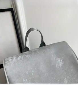 Detail of durable gray nylon top handle and high-quality PU fabric on a minimalist backpack