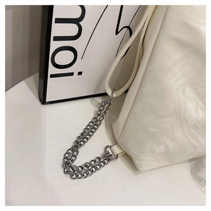 Detail of marble texture finish with silver metal chain and wide strap on tote bag