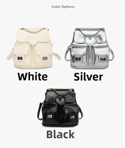Three mini backpacks in white, silver, and black with heart flaps and metal chain details
