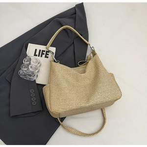 Detail of checkered woven hobo bag with silver zipper and adjustable shoulder strap